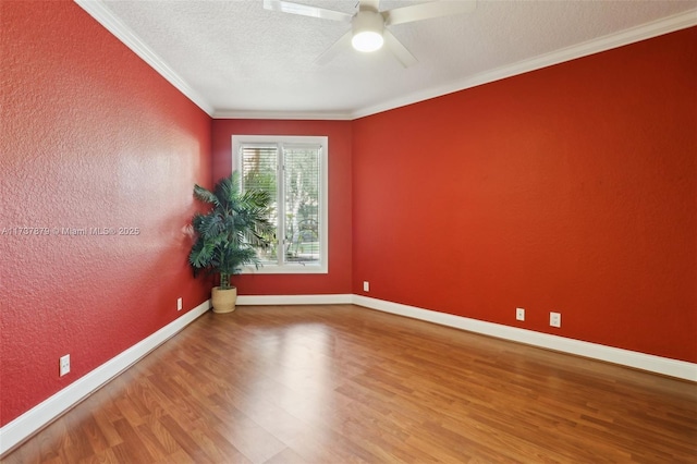 empty room with hardwood / wood-style floors, ornamental molding, a textured ceiling, and ceiling fan