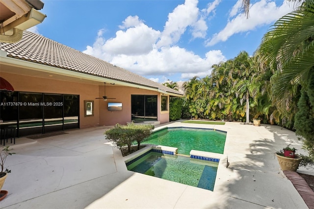 view of swimming pool with a patio, ceiling fan, and an in ground hot tub