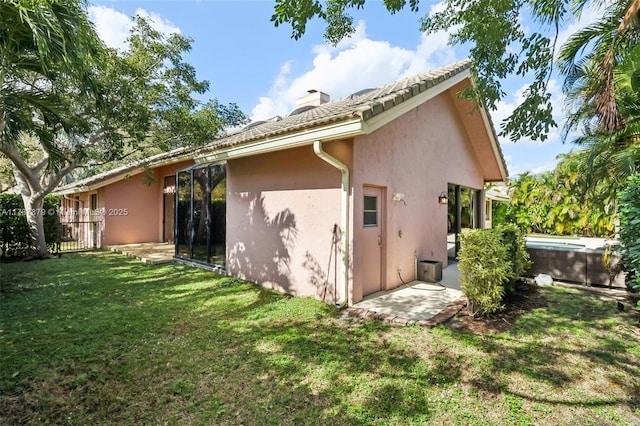 back of house with a lawn