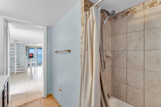 bathroom with tile patterned flooring and shower / tub combo with curtain