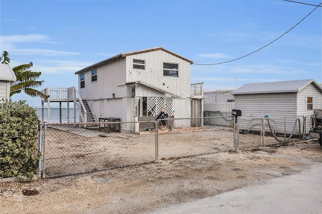 back of property featuring a water view