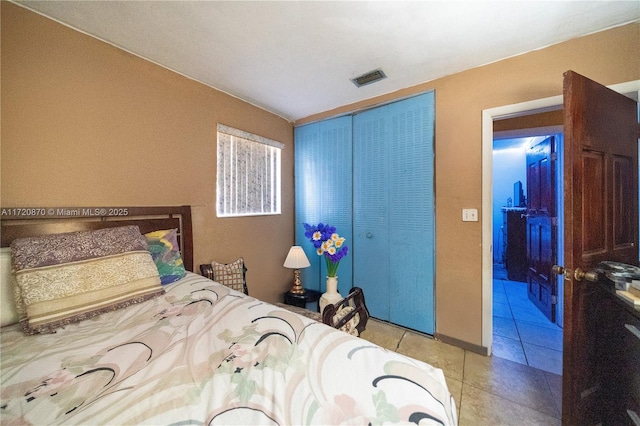 tiled bedroom with a closet