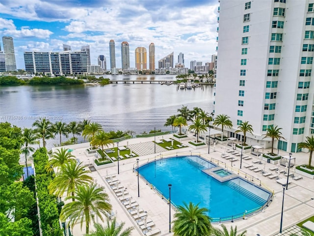 view of pool with a patio and a water view