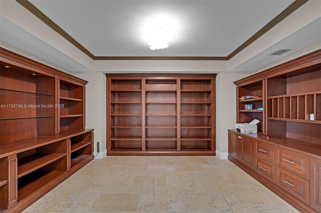 unfurnished office with ornamental molding and built in desk