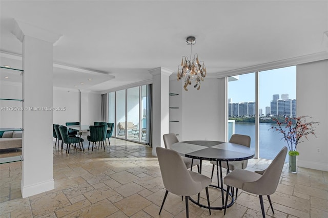 dining area with crown molding, a water view, an inviting chandelier, and a wall of windows