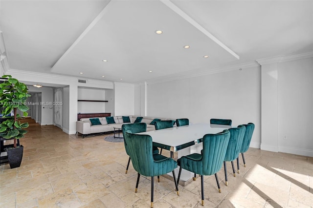 dining space featuring crown molding