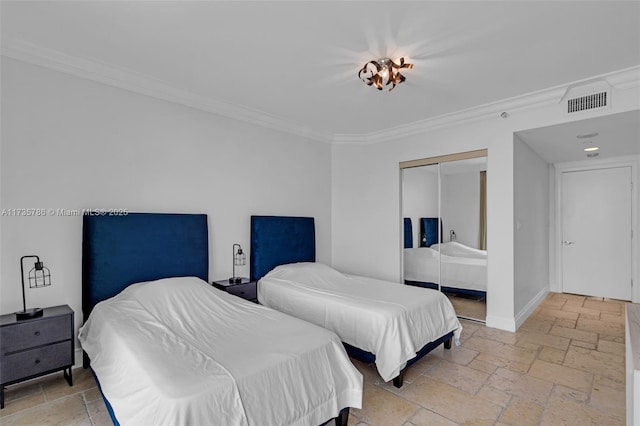 bedroom with crown molding and a closet