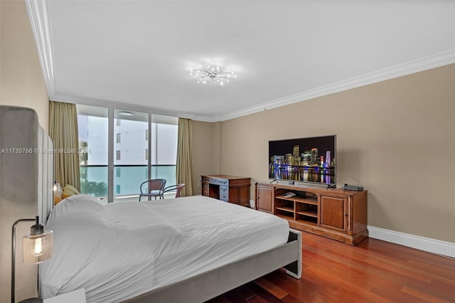 bedroom featuring hardwood / wood-style flooring, ornamental molding, and floor to ceiling windows