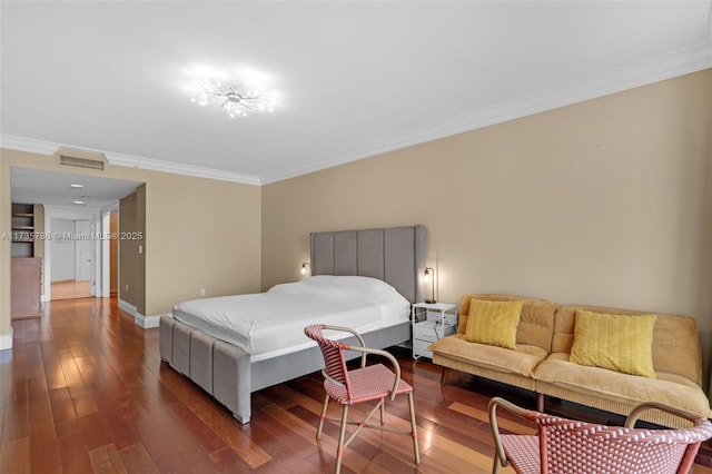 bedroom with ornamental molding and dark hardwood / wood-style flooring