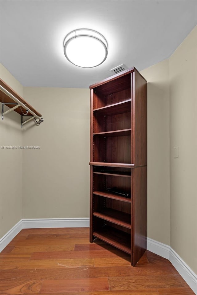 spacious closet with light hardwood / wood-style flooring