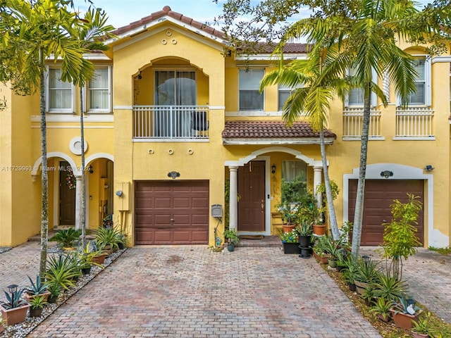 view of front of home with a garage and a balcony