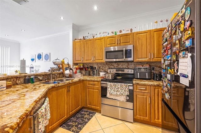 kitchen with sink, crown molding, appliances with stainless steel finishes, backsplash, and light tile patterned flooring