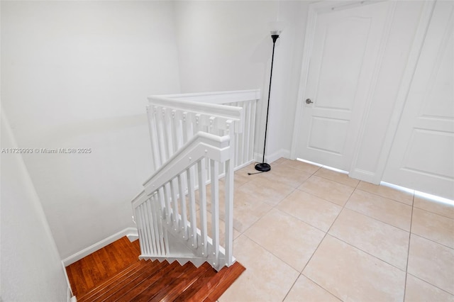 stairway with tile patterned floors