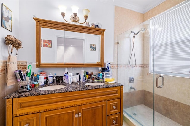 bathroom with an enclosed shower, vanity, and ornamental molding