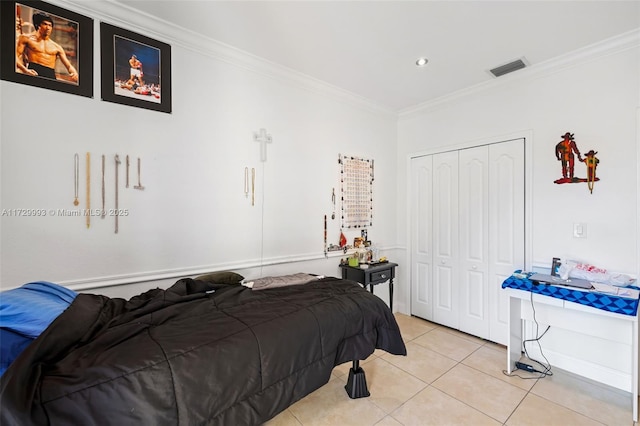 tiled bedroom featuring crown molding and a closet