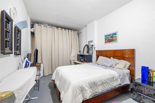 bedroom featuring concrete floors