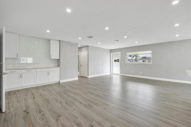 unfurnished living room featuring light hardwood / wood-style floors