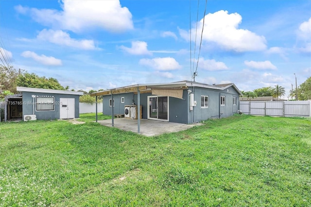 rear view of property featuring ac unit, a patio area, and a lawn