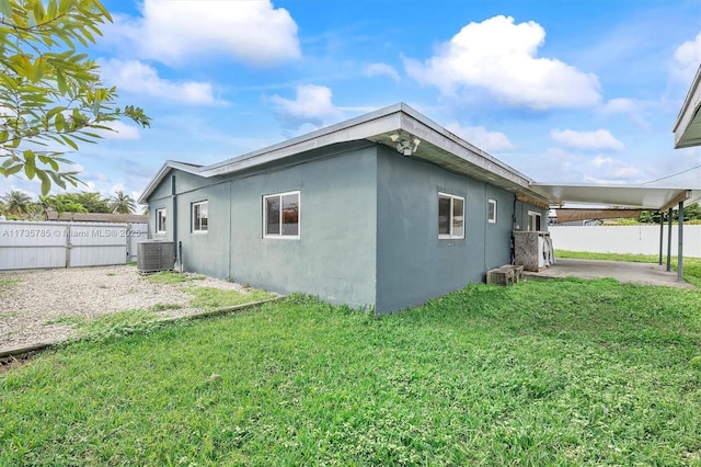 view of property exterior featuring central AC and a lawn