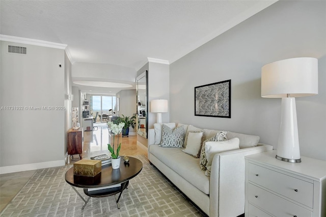 living room with ornamental molding and a textured ceiling