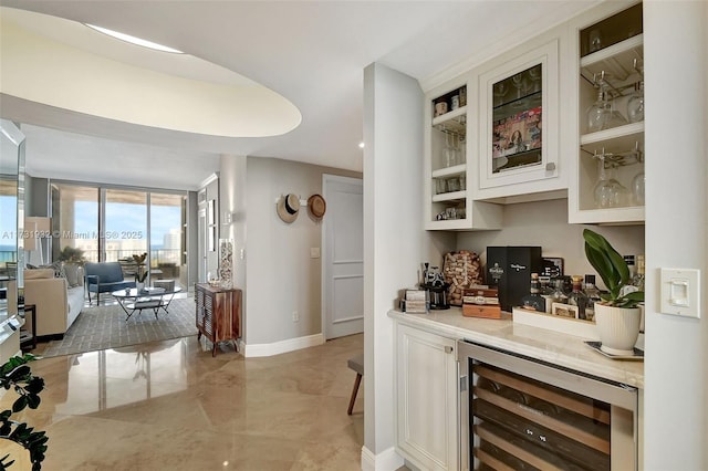 bar with wine cooler, white cabinetry, and floor to ceiling windows