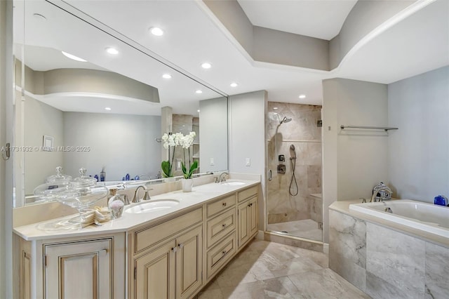 bathroom featuring vanity and independent shower and bath