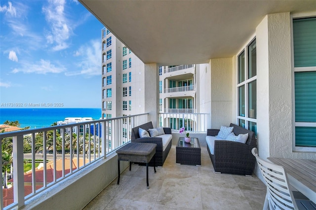 balcony featuring a water view and an outdoor hangout area