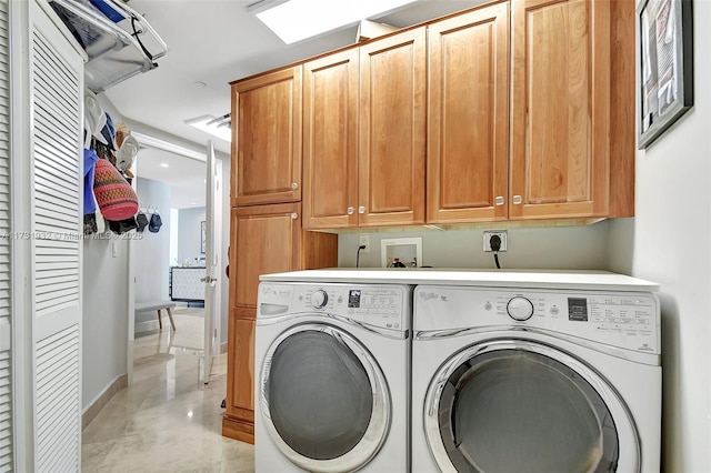 washroom with cabinets and washer and dryer