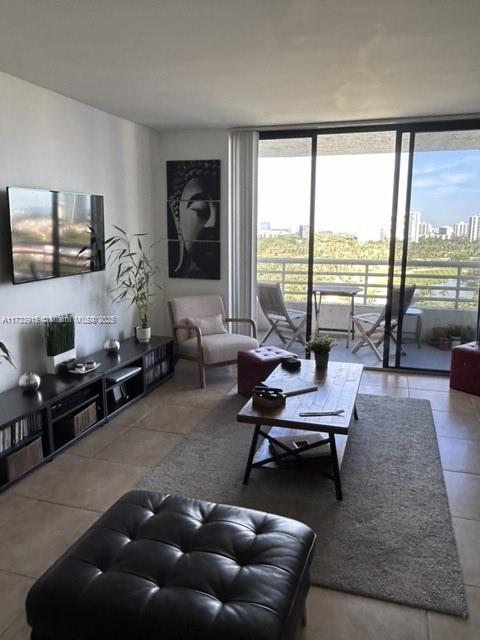 living room featuring tile patterned flooring and floor to ceiling windows