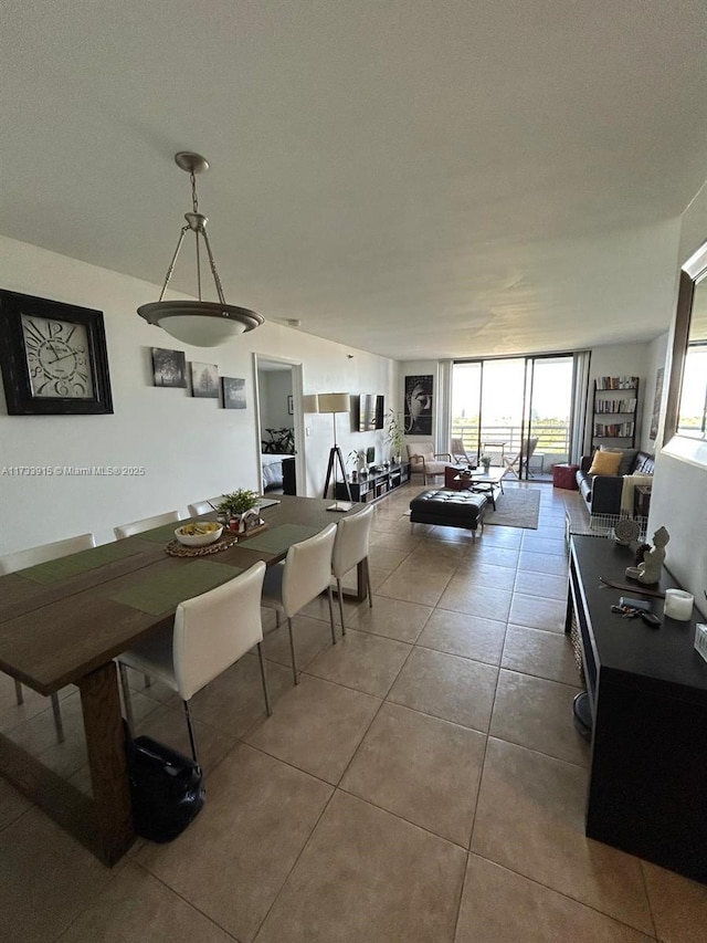 dining room featuring a wall of windows and tile patterned floors