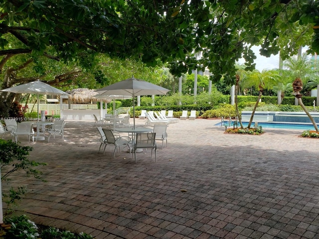 surrounding community featuring a swimming pool and a patio