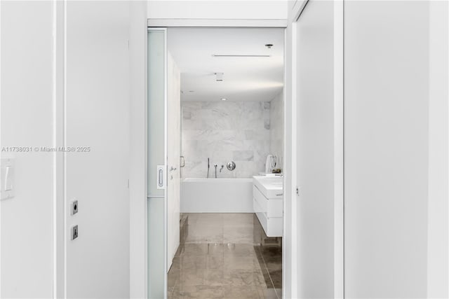 bathroom featuring a tub to relax in and vanity