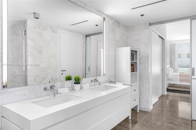 bathroom featuring vanity and tile walls