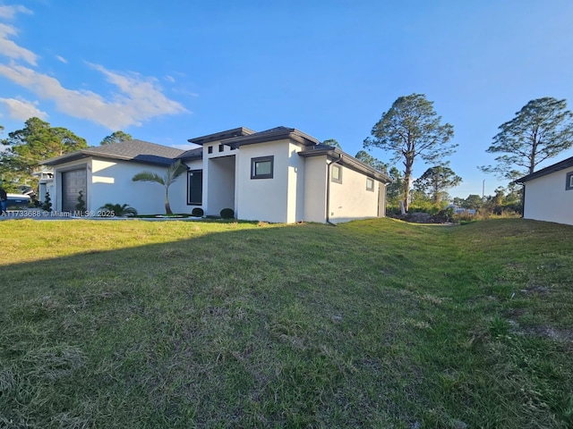 exterior space featuring a garage and a lawn