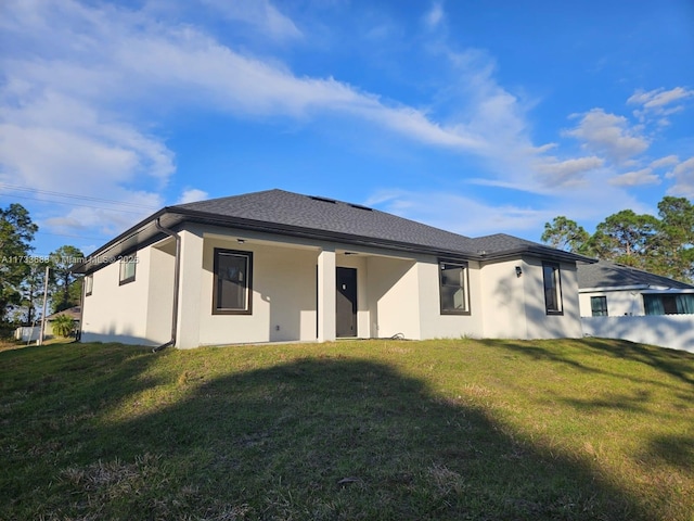 back of house featuring a yard