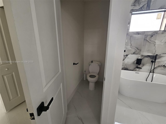 bathroom featuring toilet and a bathing tub