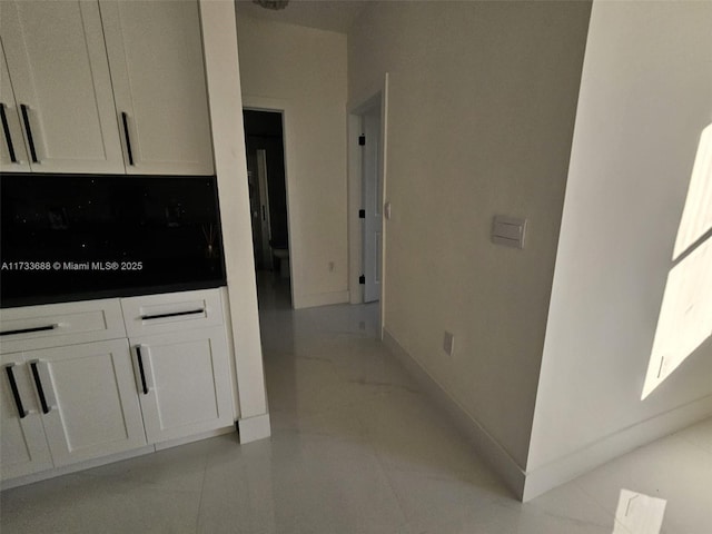 hallway featuring light tile patterned flooring