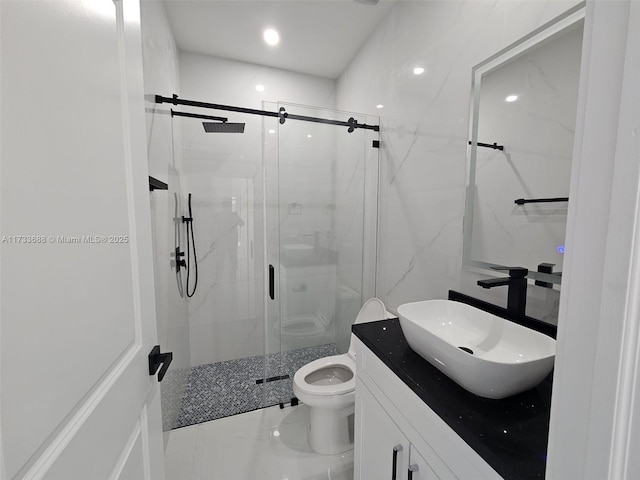 bathroom with an enclosed shower, vanity, tile walls, and toilet