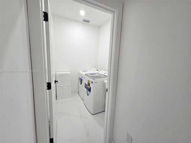 laundry area with washing machine and clothes dryer