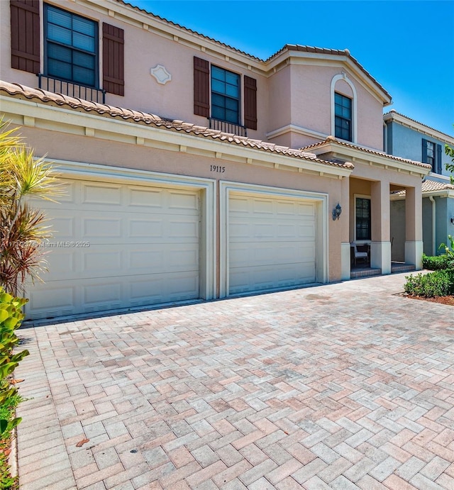 mediterranean / spanish-style house with a garage