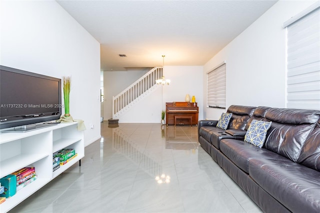 living room with light tile patterned floors and a notable chandelier