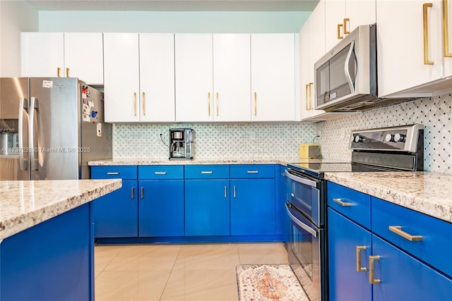 kitchen featuring white cabinetry, light stone counters, stainless steel appliances, and blue cabinets