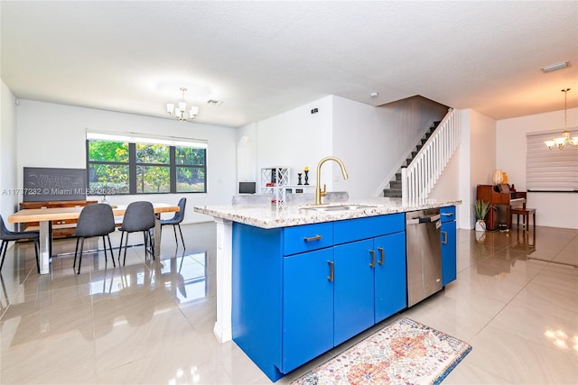 kitchen featuring blue cabinets, sink, an inviting chandelier, a center island with sink, and pendant lighting