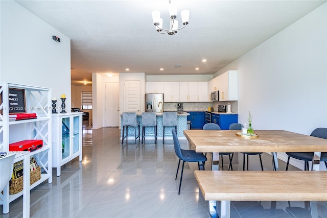 dining room featuring an inviting chandelier and sink