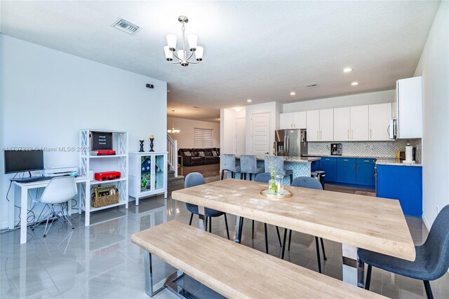 dining area featuring an inviting chandelier