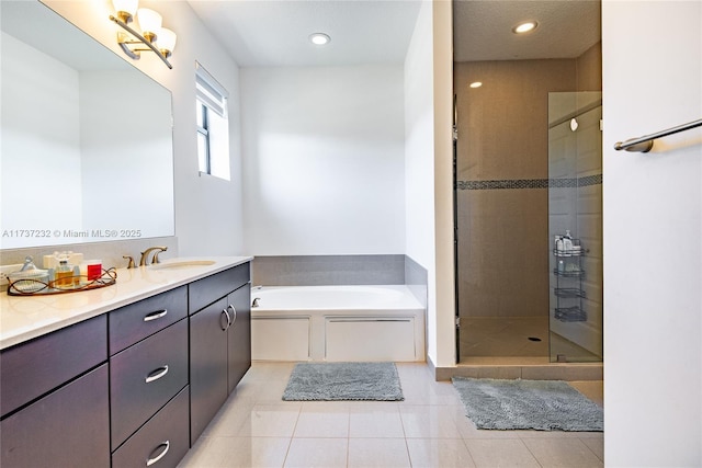 bathroom featuring tile patterned flooring, vanity, and separate shower and tub