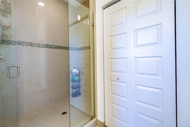 bathroom featuring a shower with shower door