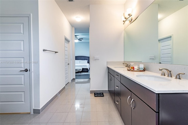 bathroom with ceiling fan, tile patterned floors, and vanity