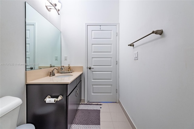 bathroom featuring vanity, tile patterned floors, and toilet