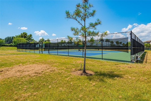 view of sport court with a lawn